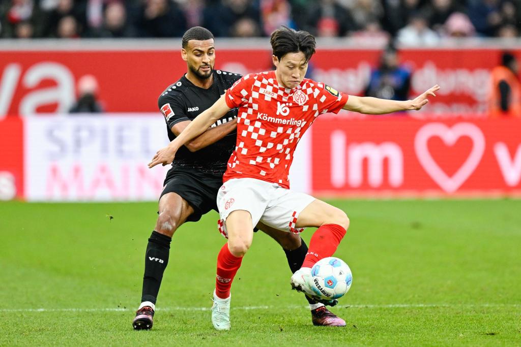 Stuttgarts Josha Vagnoman (l) und Jae-Sung Lee von Mainz 05 lieferten sich ein packendes Duell. - Foto: Uwe Anspach/dpa